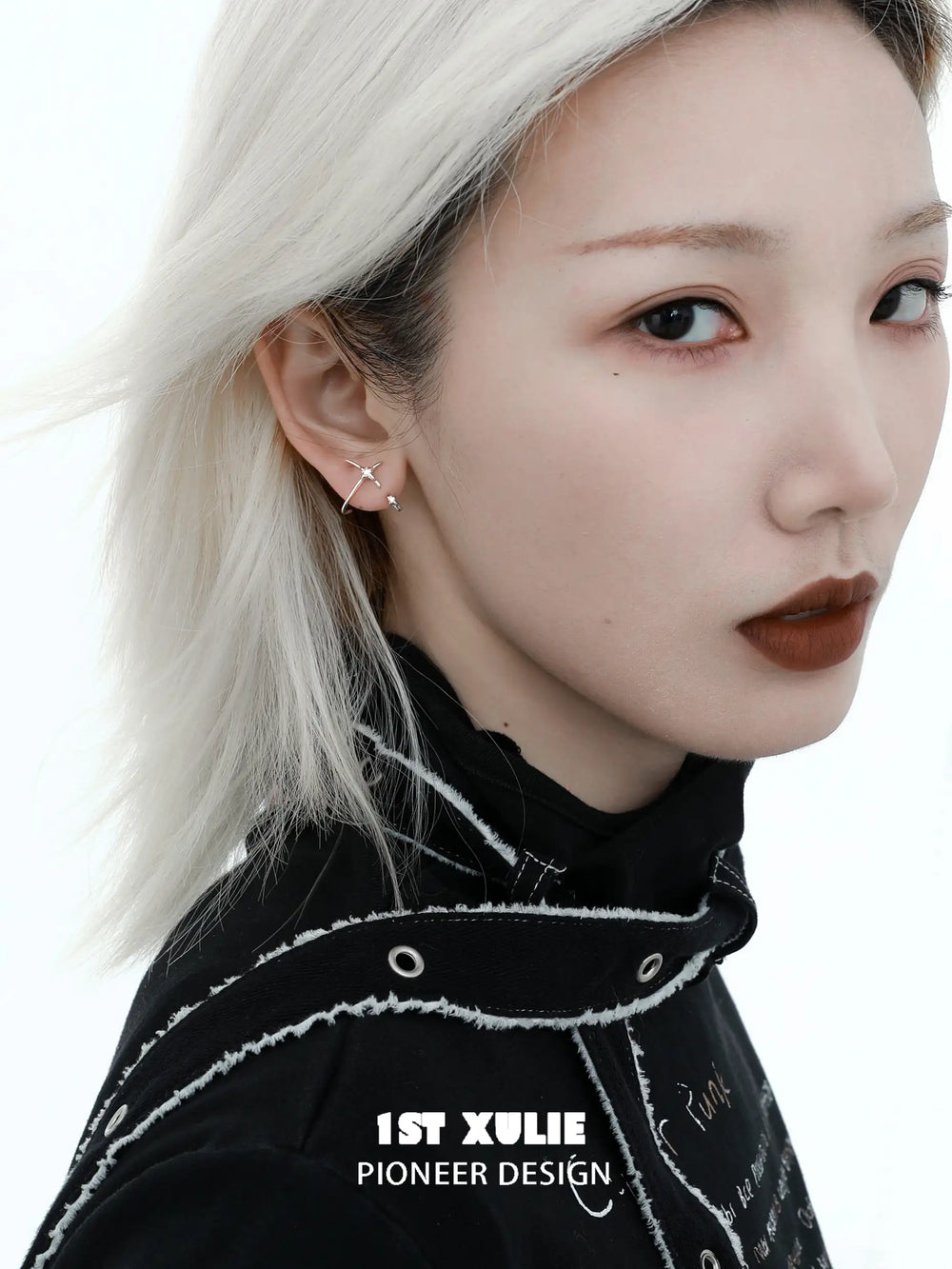 1ST XULIE "Silver Angel" Angel Hook Zircon Stud Earrings in Platinum Plated 925 Sterling Silver - Product View on textured background