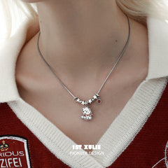 1ST XULIE "MERRY CHRISTMAS 2024" Statement Graffiti Puppy Holiday Necklace in Platinum Plated Brass - On Model