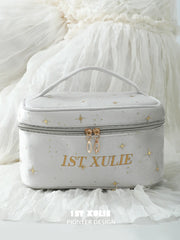 Close-up of the light gray velvet makeup bag, carry handle and 1ST XULIE branding.