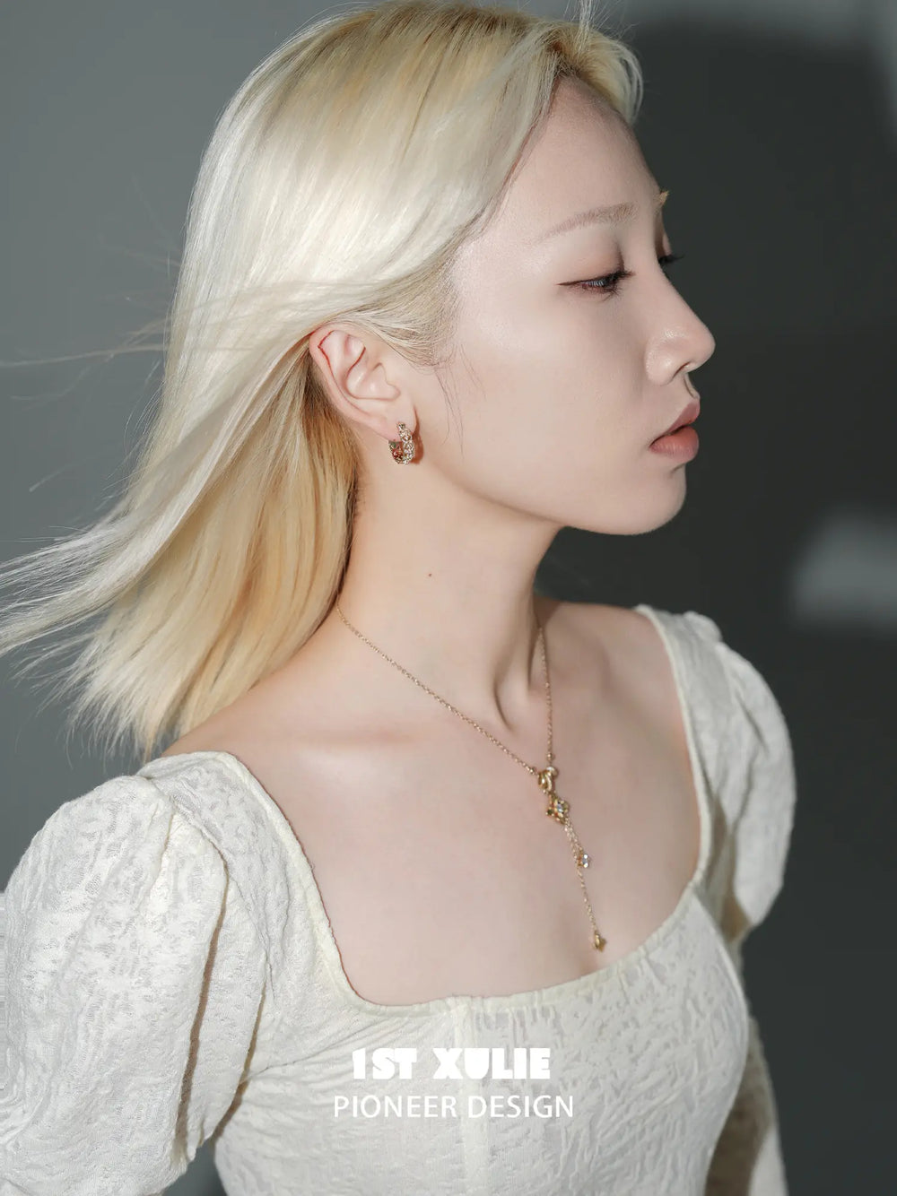 1ST XULIE "Bastet" Iris Blossom Huggie Hoop Earrings in Rhodium Plated - Lifestyle Shot