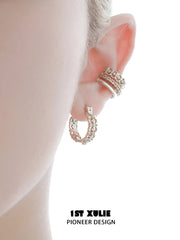 1ST XULIE "Bastet" Iris Blossom Huggie Hoop Earrings in Rhodium Plated - Detail Shot