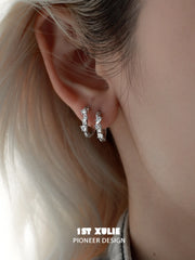 1ST XULIE "Star Trails" Möbius Twist Pavé Huggie Earrings in 925 Sterling Silver - On Model