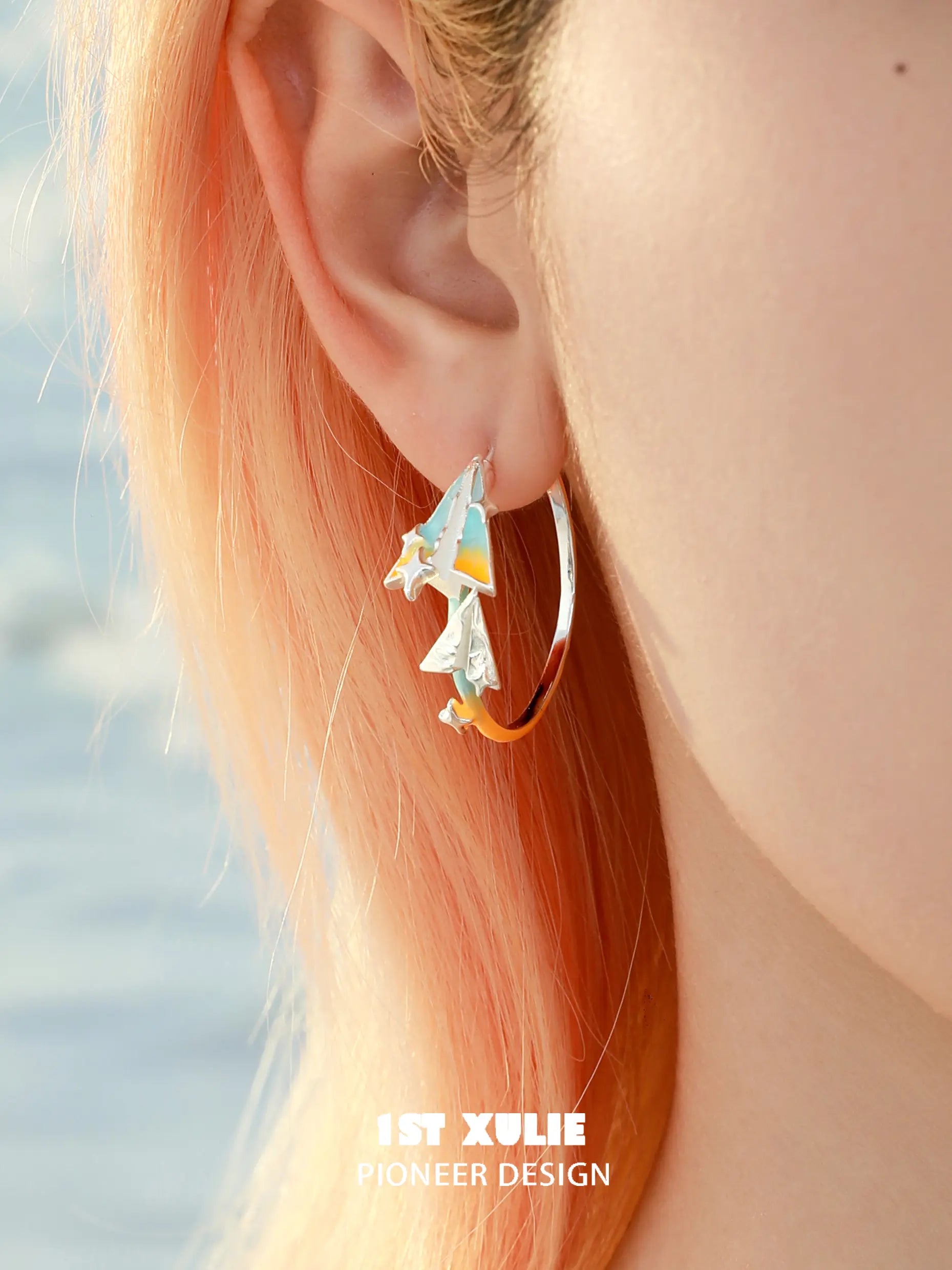 1ST XULIE "Juicy Flight" Paper Airplane Statement Charm Hoop Earrings in Platinum Plated - On Model 1ST XULIE "Juicy Flight" Paper Airplane Statement Charm Hoop Earrings in Platinum Plated - On Model