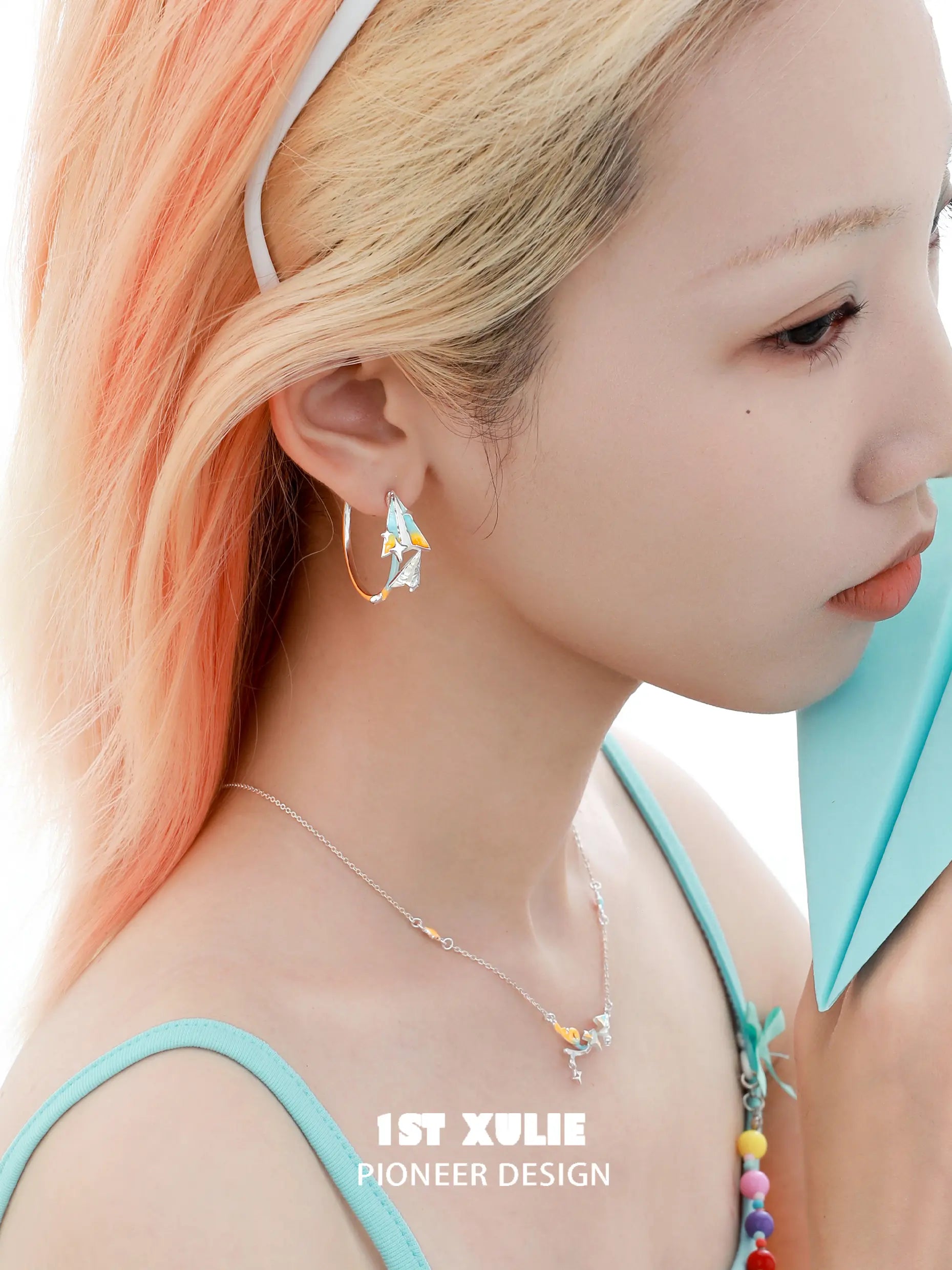 1ST XULIE "Juicy Flight" Paper Airplane Statement Charm Hoop Earrings in Platinum Plated - On Model Close-Up 1ST XULIE "Juicy Flight" Paper Airplane Statement Charm Hoop Earrings in Platinum Plated - On Model Close-Up