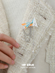1ST XULIE "Juicy Flight" Playful Paper Plane Chain Brooch in Platinum Plated Brass - Angle View
