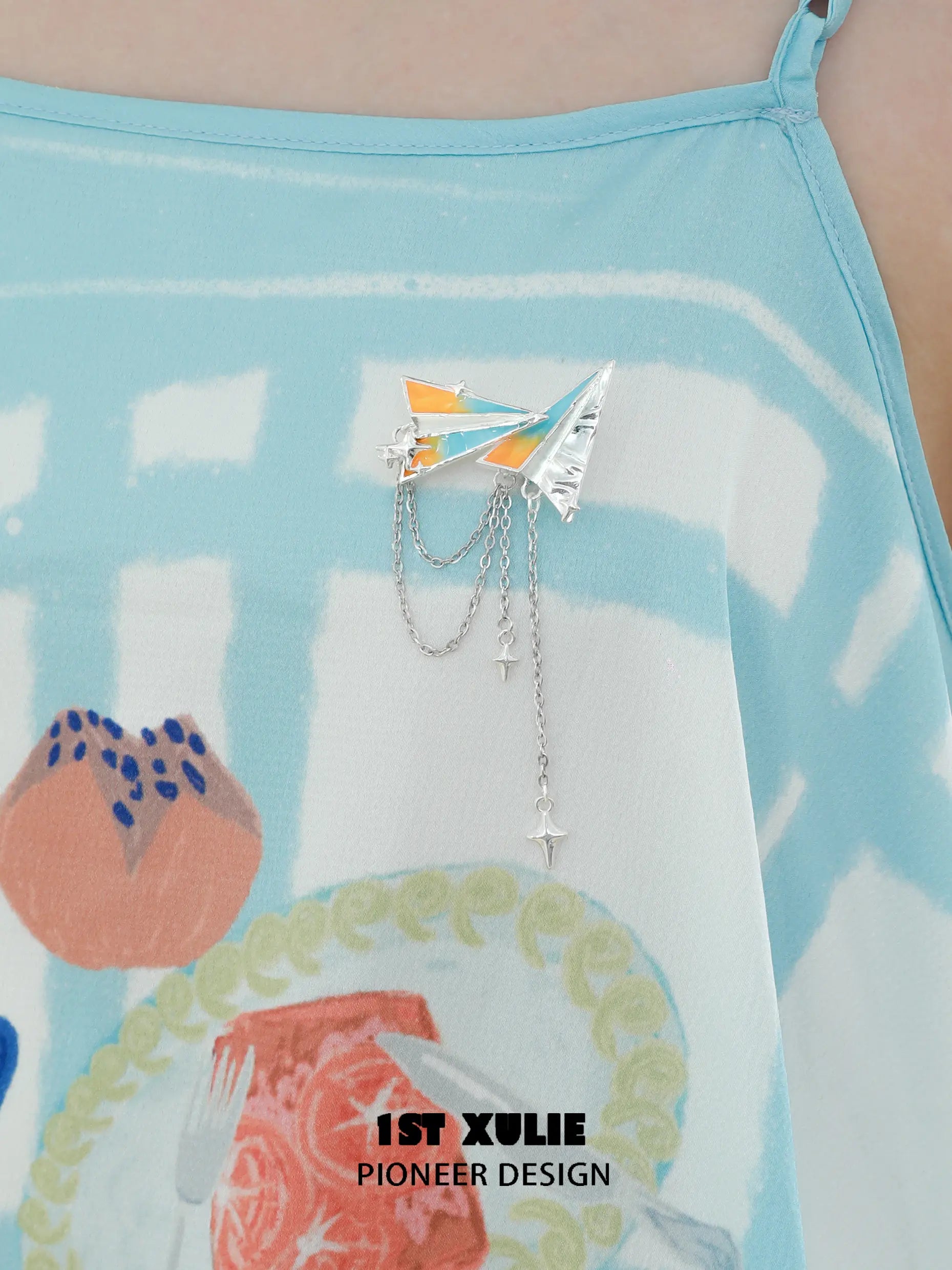 1ST XULIE "Juicy Flight" Playful Paper Plane Chain Brooch in Platinum Plated Brass - Lifestyle Shot 1ST XULIE "Juicy Flight" Playful Paper Plane Chain Brooch in Platinum Plated Brass - Lifestyle Shot
