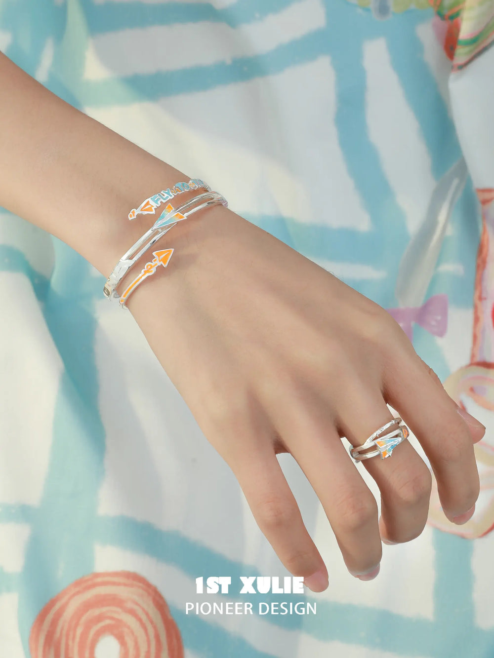 1ST XULIE Jewelry "Juicy Flight" Playful Paper Plane Cuff Bracelet in Platinum Plated Brass - Detail Shot