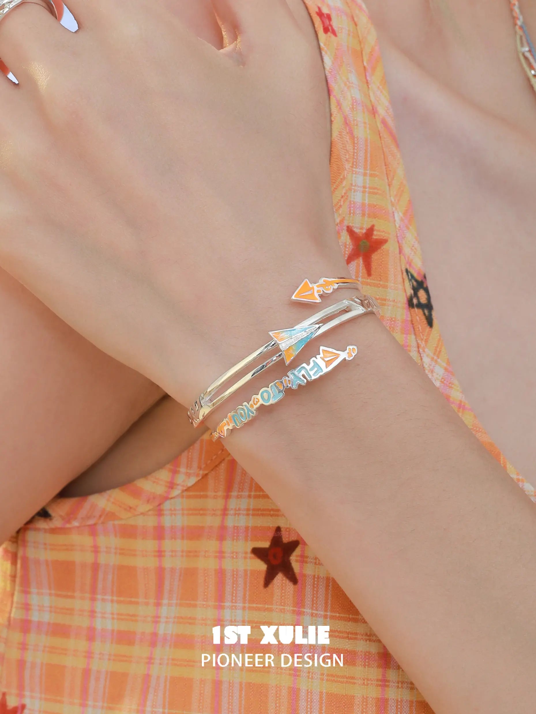 1ST XULIE Jewelry "Juicy Flight" Playful Paper Plane Cuff Bracelet in Platinum Plated Brass - On Model 1ST XULIE Jewelry "Juicy Flight" Playful Paper Plane Cuff Bracelet in Platinum Plated Brass - On Model