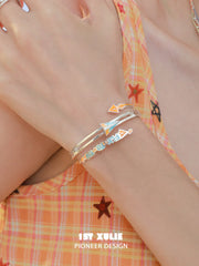 1ST XULIE Jewelry "Juicy Flight" Playful Paper Plane Cuff Bracelet in Platinum Plated Brass - On Model