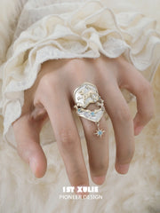 Celestial armor ring with a hanging star worn with coordinating jewelry