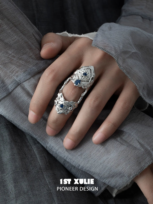 Blue stone articulated ring worn with coordinating jewelry