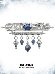 Blue stone tassel brooch showing the ornamental details and overall silhouette