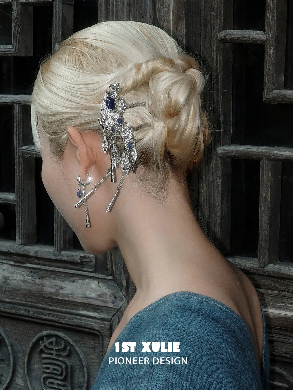 Blue stone tassel hair pin positioned beside a braided updo