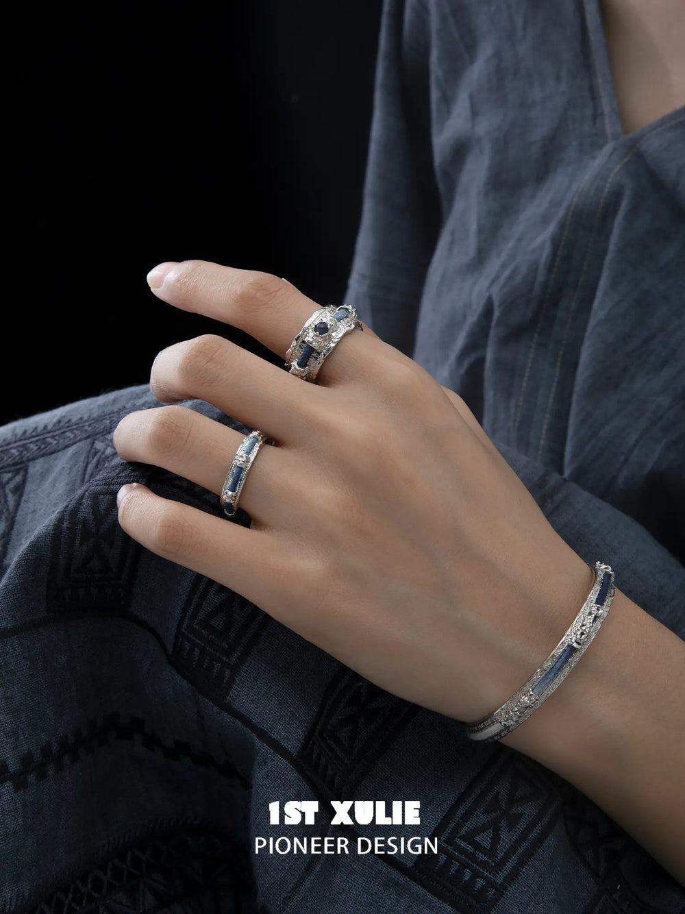 Side view of narrow and wide woven rings on the fingers