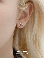 Small fleur-de-lis stud worn without the long detachable ornament
