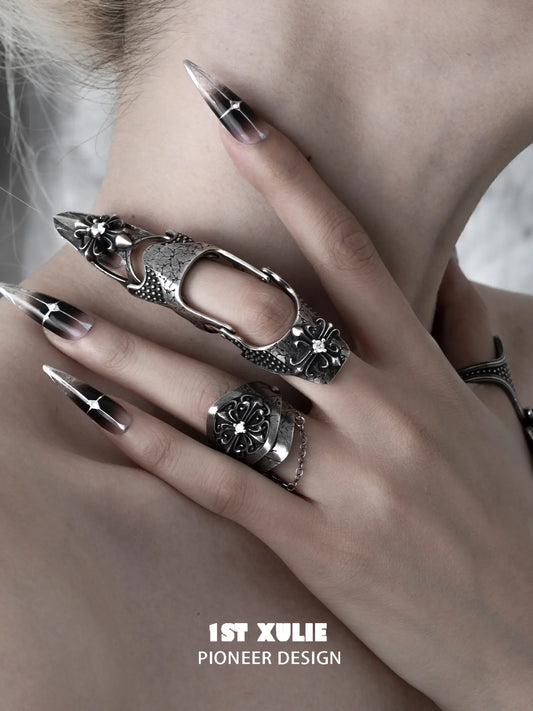Gothic long armor and chain signet rings worn with coordinating jewelry