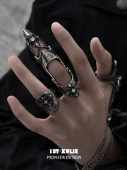 Gothic chain signet and long armor rings worn with coordinating jewelry