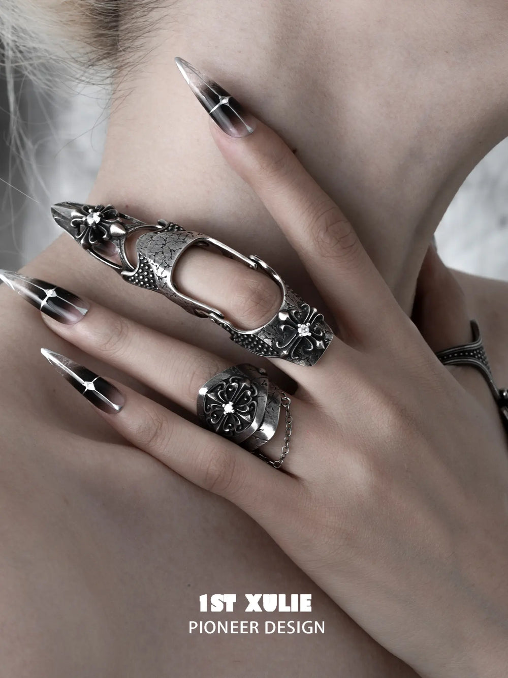 Gothic chain signet and long armor rings worn with coordinating jewelry