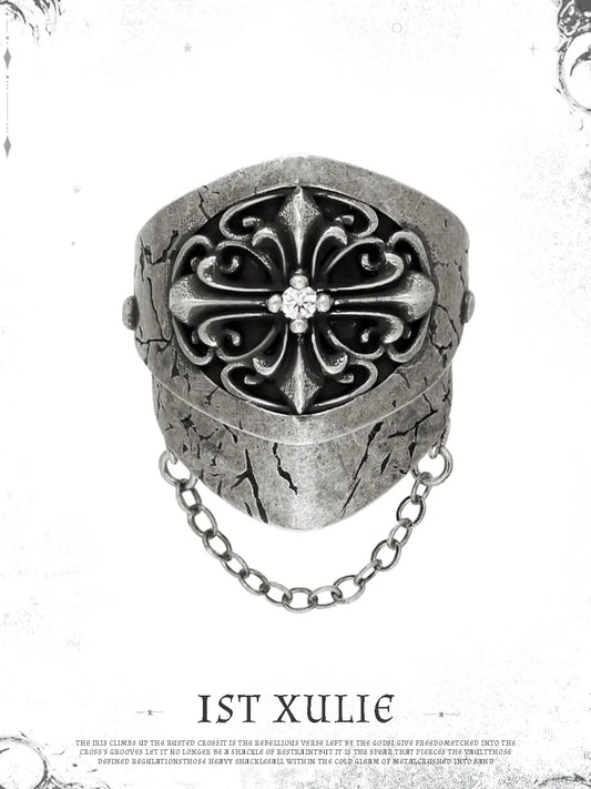 Short gothic signet ring against a pale decorative border