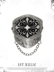 Short gothic signet ring against a pale decorative border