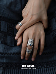 Wide blue woven open ring worn with coordinating jewelry