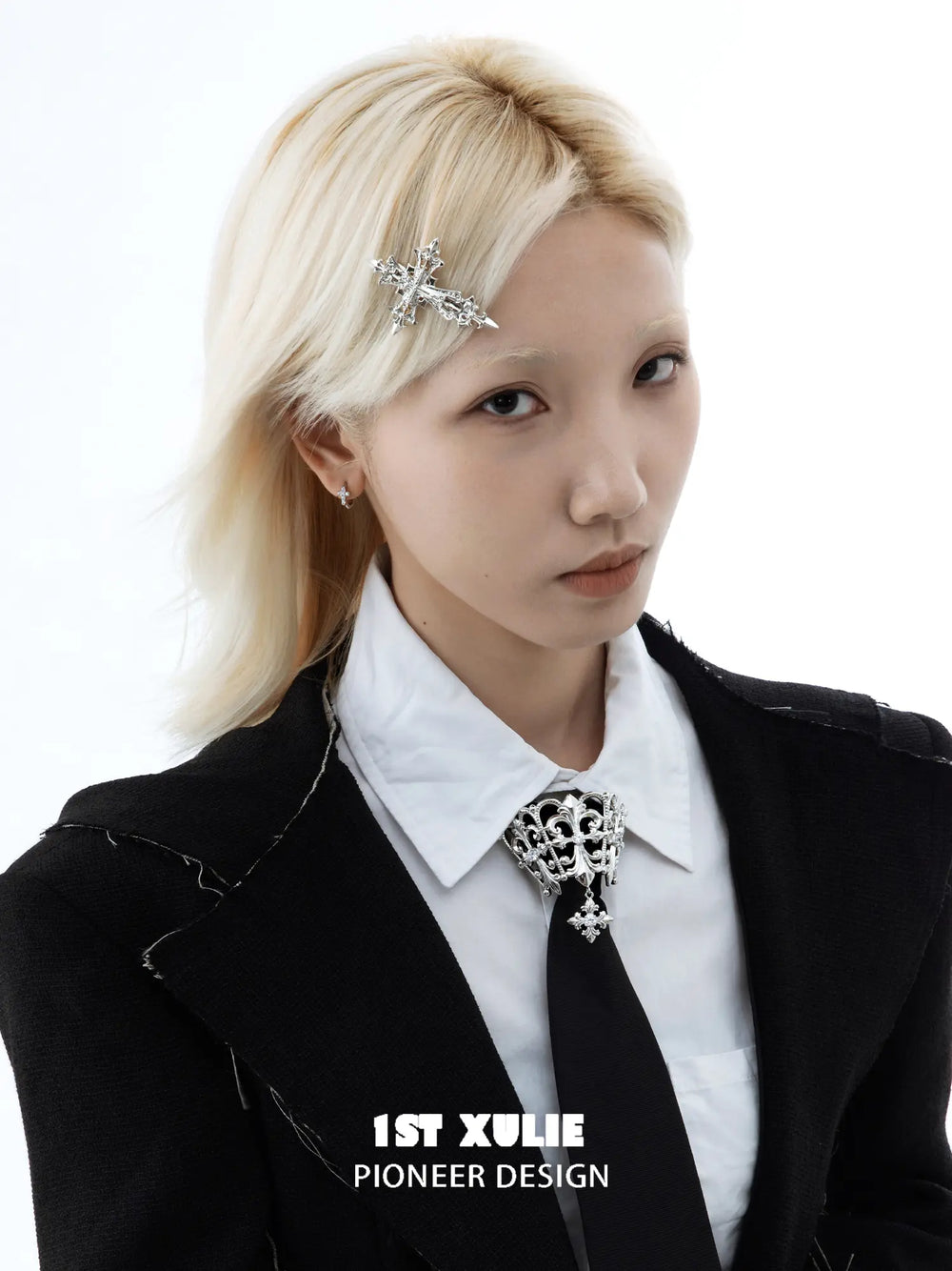 Silver-tone Fleur-de-Lis cross hair clip styled with a black-and-white outfit.