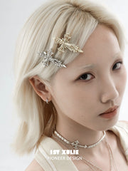 Fleur-de-Lis hair clips styled with layered jewelry; one random-color clip is included.