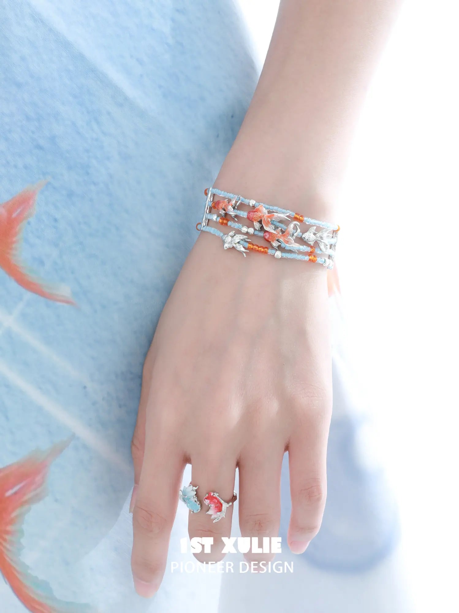 1ST XULIE Jewelry "THE SEA" Whimsical Goldfish Beaded Charm Bracelet in Brass - Lifestyle Shot