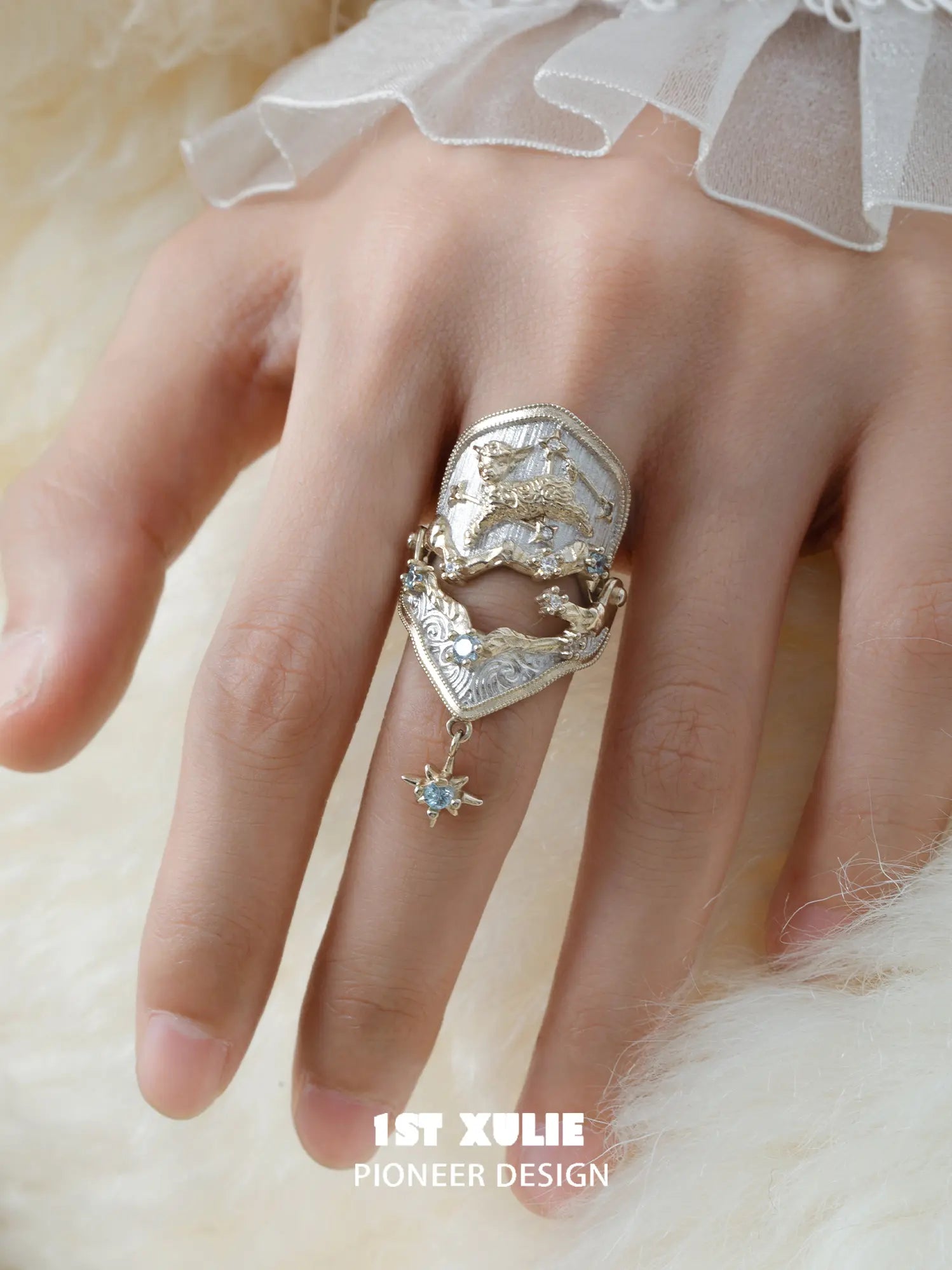 Celestial armor ring with a hanging star worn with coordinating jewelry