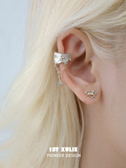 Miniature gold-toned ram stud earrings worn on the lobe