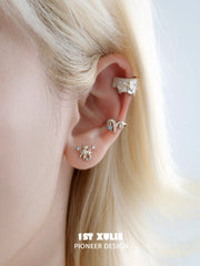 Celestial ram and star ear cuffs worn along the ear