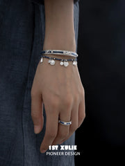 Beaded bracelet and slim bangle worn on the wrist