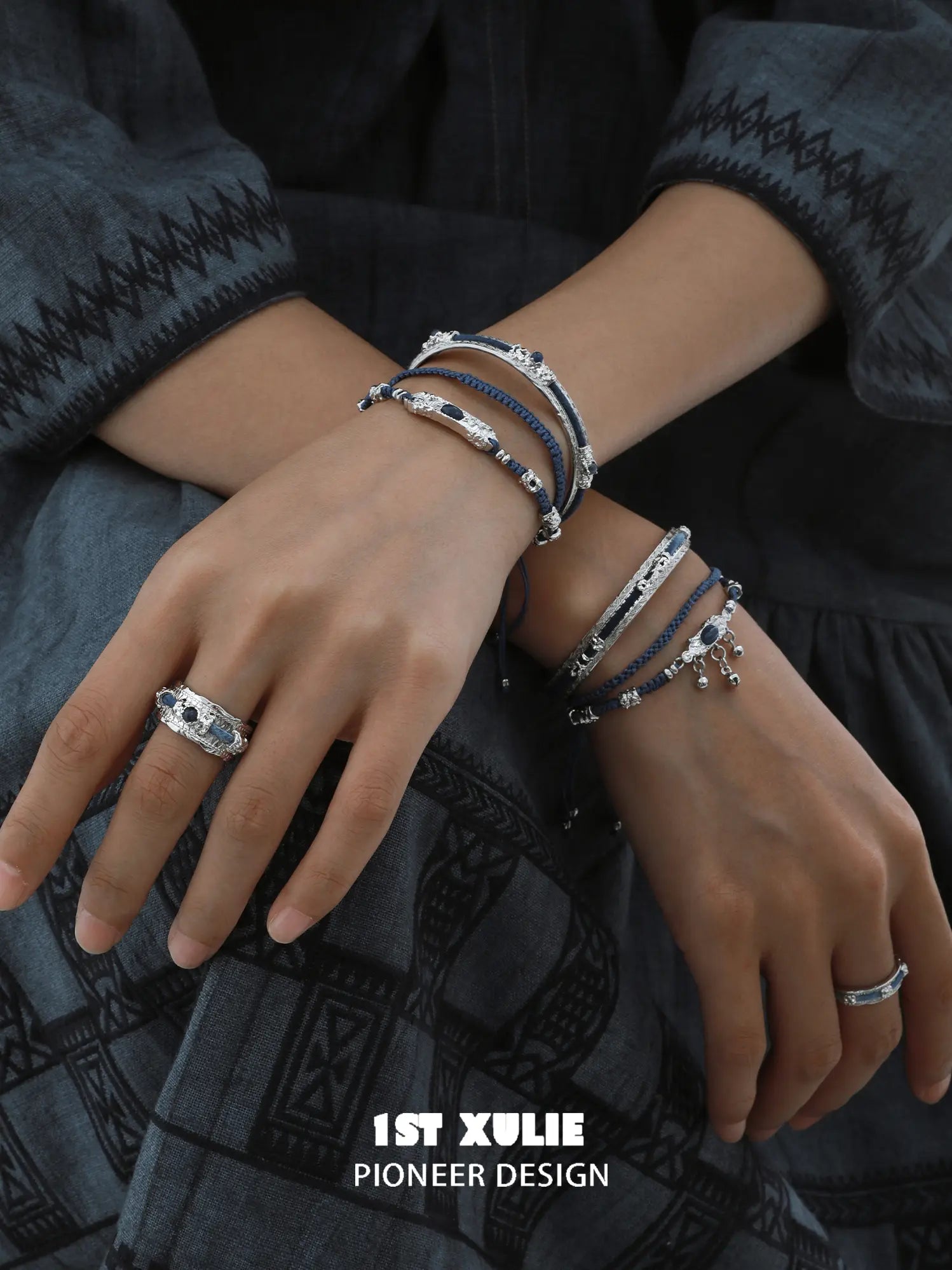 Blue braided charm bracelets worn with coordinating jewelry