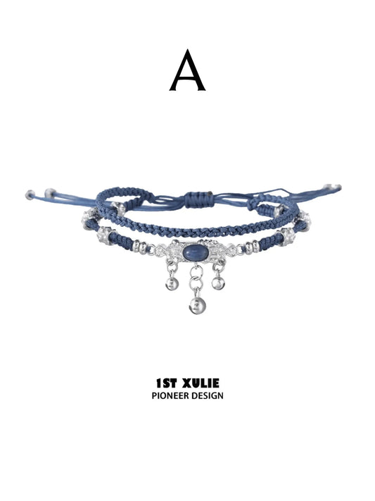 Style A blue braided bracelet with hanging silver-toned charms