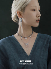 Blue cord and tassel layering necklaces layered at the neckline