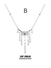 Style B fine-chain necklace with blue accents and hanging tassels