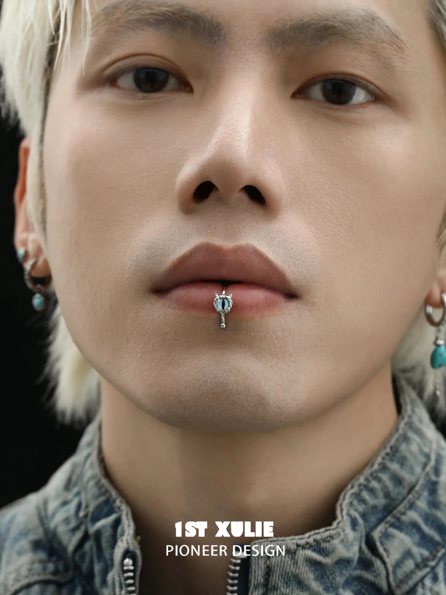 Blue eye lip cuff worn at the center of the lower lip