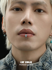 Blue eye lip cuff worn at the center of the lower lip
