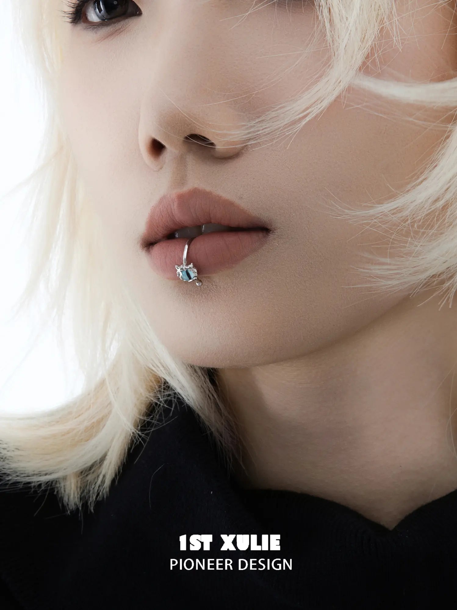 Close-up of the blue eye lip cuff worn on the lower lip