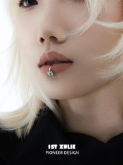 Close-up of the blue eye lip cuff worn on the lower lip