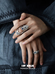 Blue stone articulated ring worn with coordinating jewelry