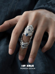 Blue stone articulated ring worn across the finger joints