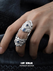 Close view of the openwork panels of the blue stone ring
