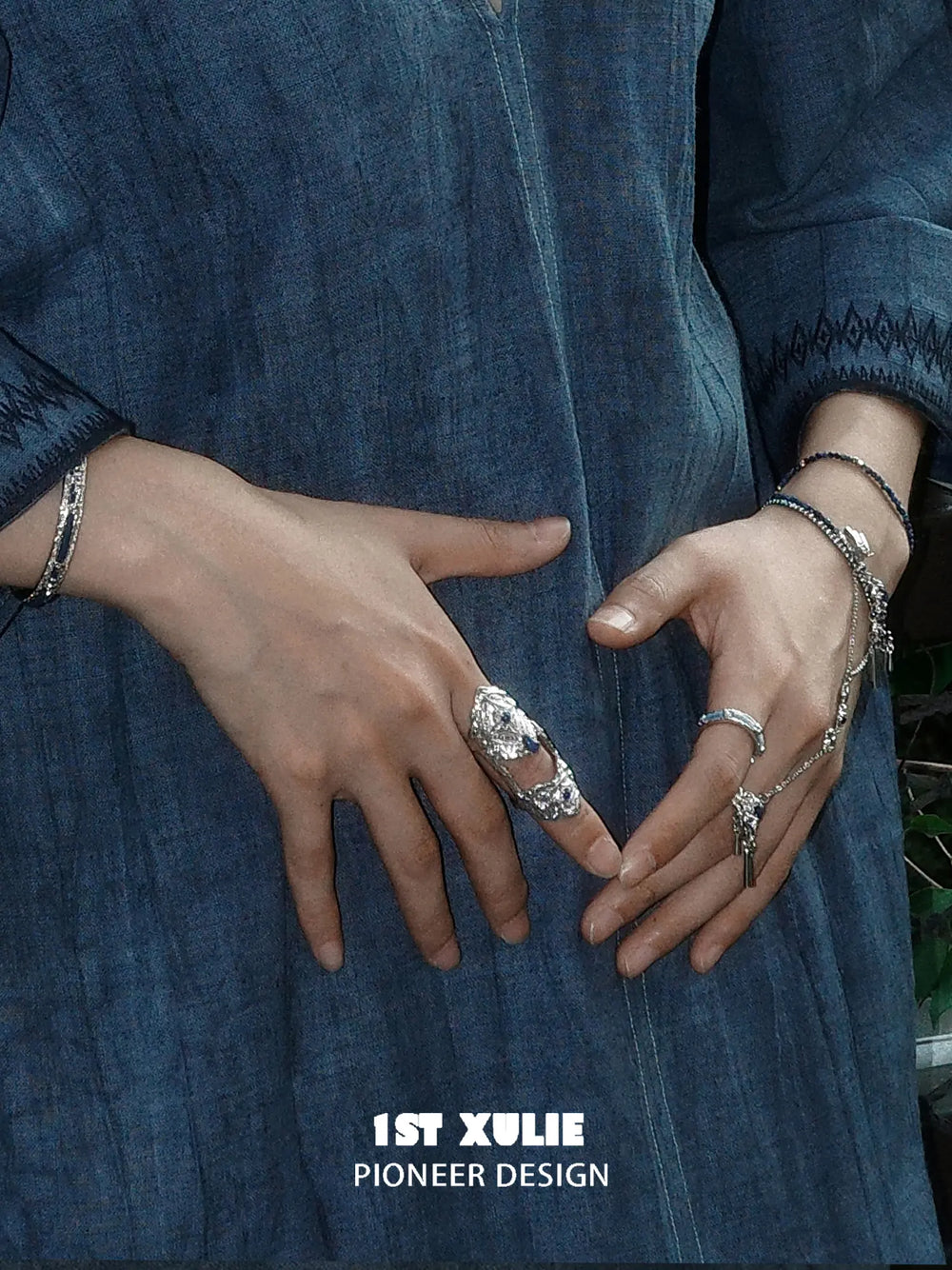 Blue stone articulated ring worn with coordinating jewelry
