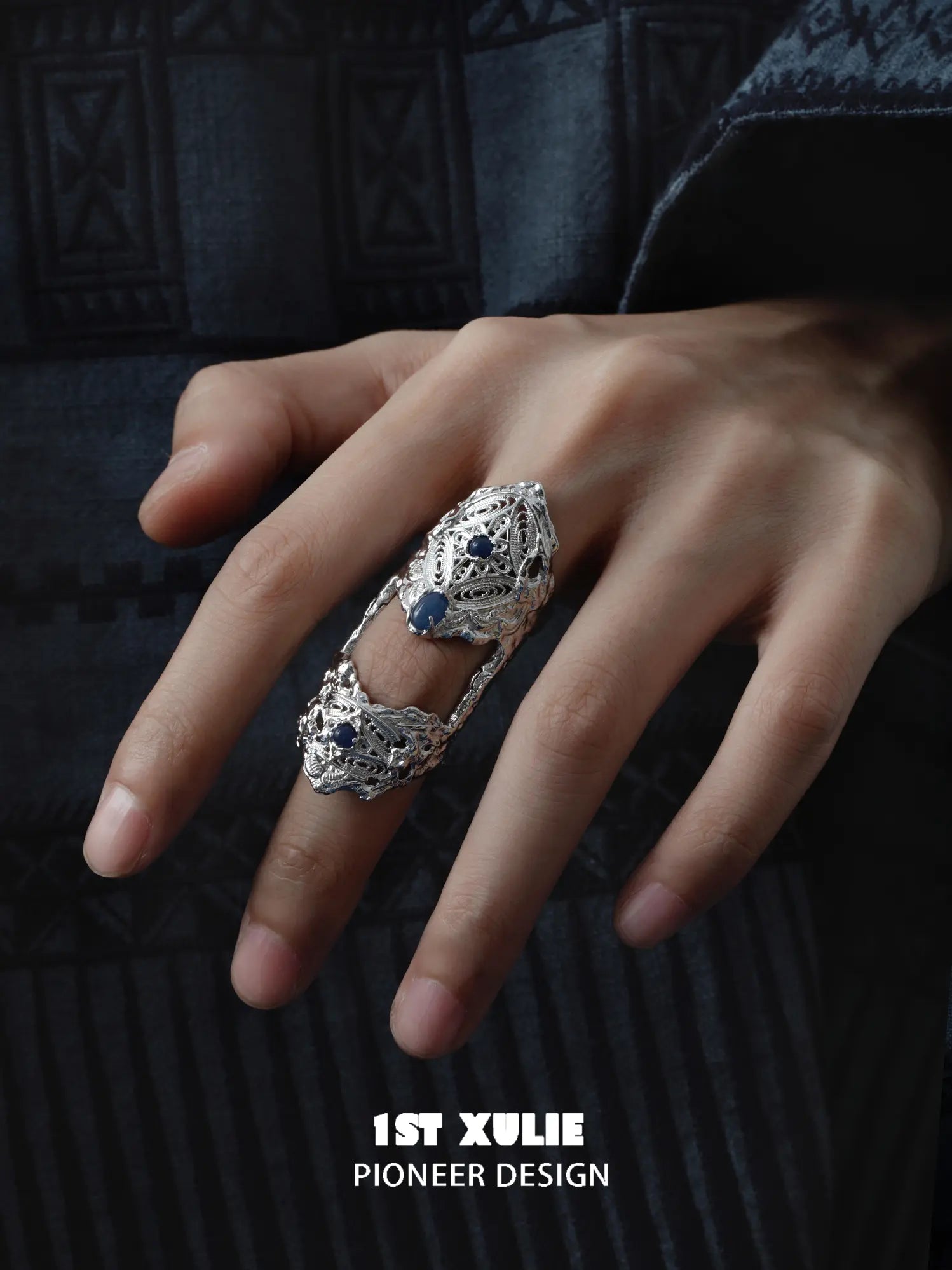 Blue stone articulated ring worn with coordinating jewelry