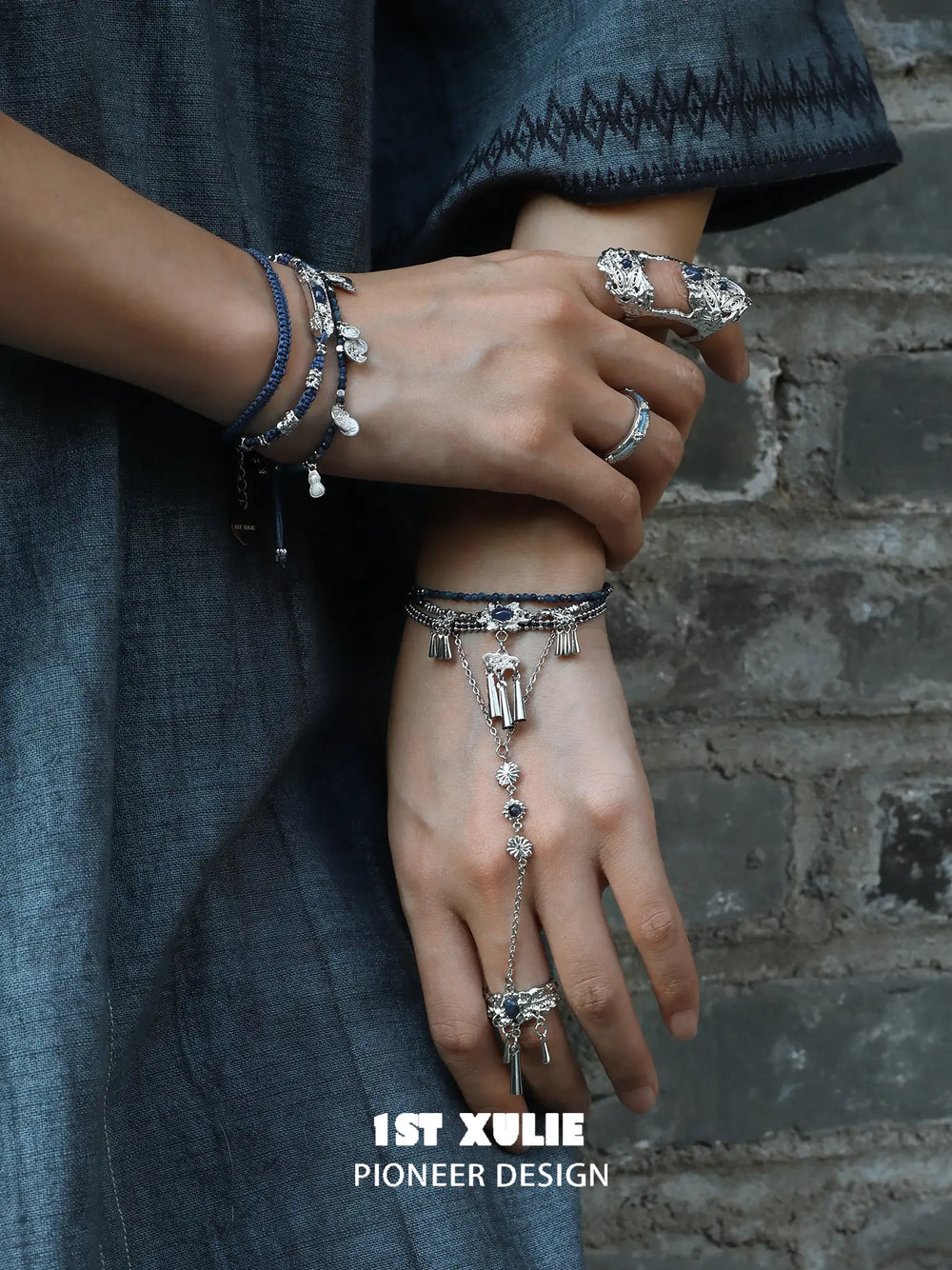 Blue stone bracelet-to-ring hand chain worn with coordinating jewelry