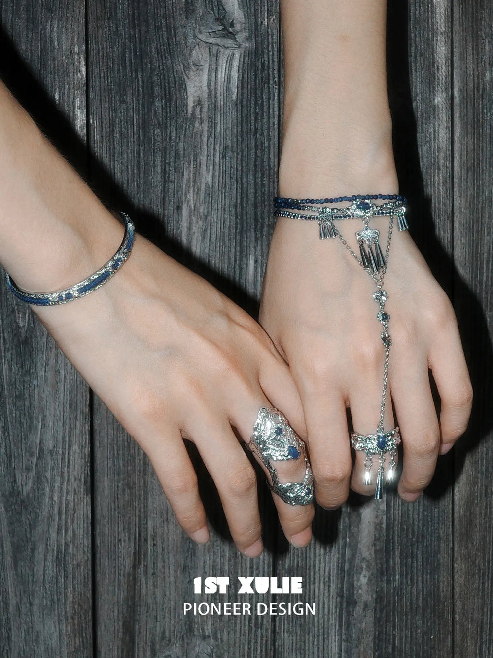 Blue hand chain worn beside a coordinating articulated ring