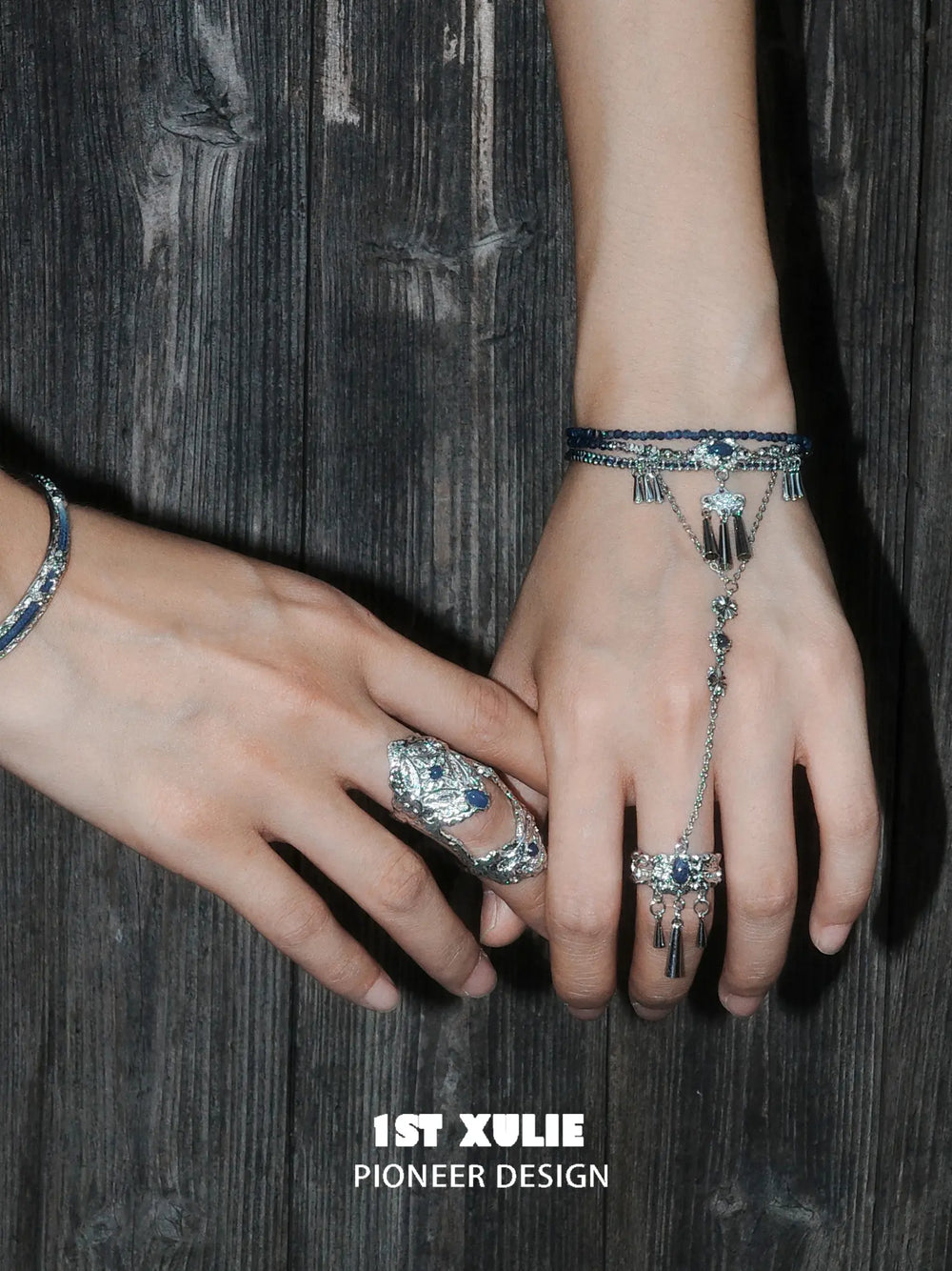 Blue stone bracelet-to-ring hand chain worn with coordinating jewelry