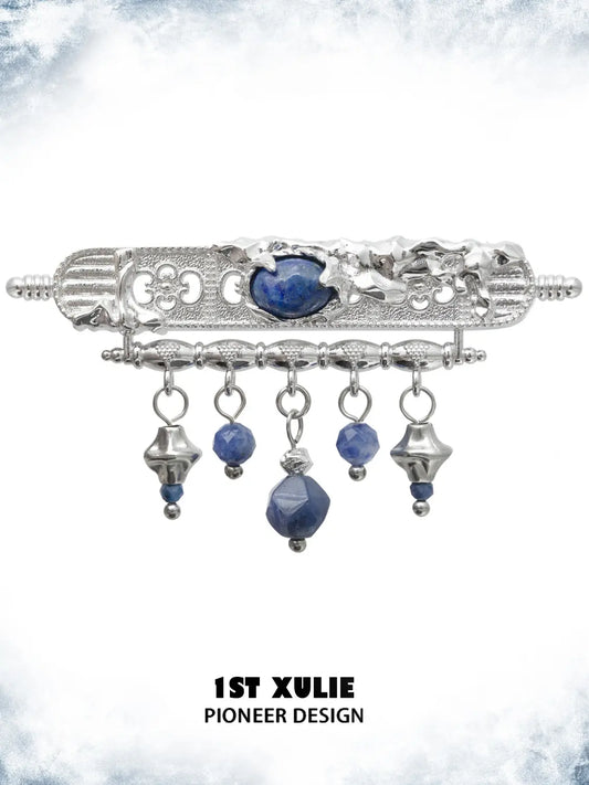 Blue stone tassel brooch showing the ornamental details and overall silhouette