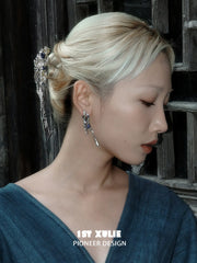 Blue stone tassel hoop earrings worn with the hair tucked back